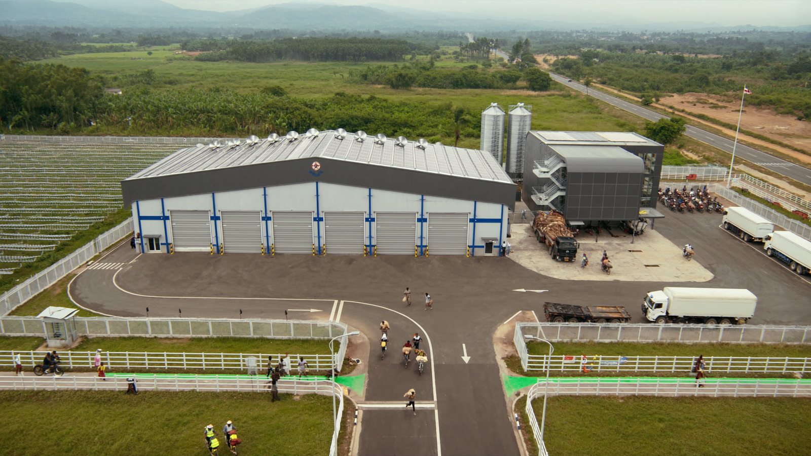 The planned facility seen from the air, with the warehouse, office wing and solar array